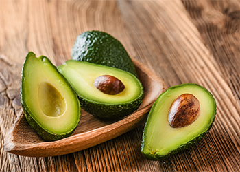 Avocado,On,Old,Wooden,Table.halfs,On,Wooden,Bowl.,Fruits,Healthy