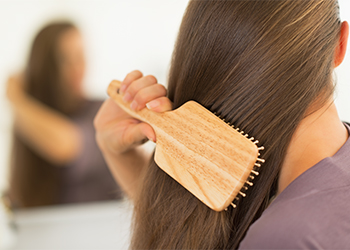 Closeup,On,Young,Woman,Combing,Hair Not Combing